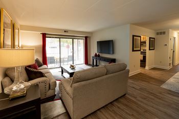 an empty room with a door and three windows at Walnut Grove Townhomes* Apartments, Maryland